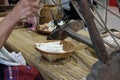 woman spinning cotton into thread with traditional wheel