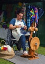 Woman Spinning wool at traditional spinning wheel.