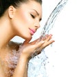 Woman with splashes of water in her hands Royalty Free Stock Photo