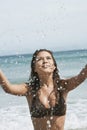 Woman Splashing Water At Beach Royalty Free Stock Photo