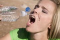 Woman splashing water on her face.