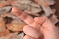 Woman with splinter in her finger on blurred background, closeup Royalty Free Stock Photo