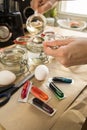 Woman with spoon, vinegar, water, and bright Easter cold colour color dye in red, orange, yellow, green, blue in packaging on Royalty Free Stock Photo