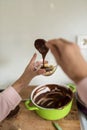 Woman spooning chocolate sauce onto bananas