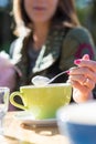 Woman spooning the froth on her cappuccino coffee