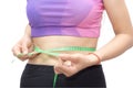 Woman in sport bra measuring her body with tape isolated on whit Royalty Free Stock Photo