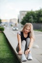 Woman in sport clothes resting on street after cycling Royalty Free Stock Photo