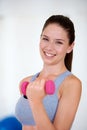 Woman, sports bra and portrait with dumbbells in studio for health wellness, training and weight loss with exercise Royalty Free Stock Photo