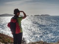 Woman in sports clothes shadowing eyes  at sea Royalty Free Stock Photo