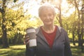 Woman in sports clothing standing in park looking at came Royalty Free Stock Photo