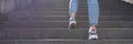 Woman in sportswear climbs up stairs closeup