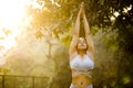 Woman in sportswear practicing yoga tree pose at park Royalty Free Stock Photo