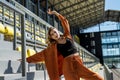 woman in sportwear stretching before her workout in stadium