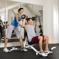 Woman spotting man at gym