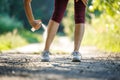 Woman spraying insect repellent against mosquito and tick on her legs