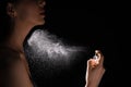 Woman spraying luxury perfume on black background, closeup Royalty Free Stock Photo