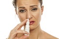 Woman spraying nasal drops