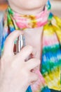 Woman sprays perfume on silk scarf from atomizer Royalty Free Stock Photo