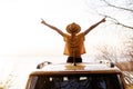 Woman Spread Arms Widely at Car Sunroof Back View Royalty Free Stock Photo