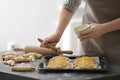 Woman spreading egg yolk on croissants closeup