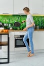 Woman spreading oil on frying pan