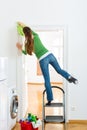 Woman at the spring cleaning working dangerously Royalty Free Stock Photo