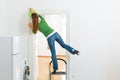 Woman at the spring cleaning working dangerously Royalty Free Stock Photo