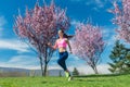 Woman in spring running or jogging as sport