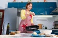 A woman sprinkles flour on a baking dish to bake a pizza. The concept of home cooking and slow food