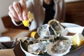 Woman sprinkles oysters