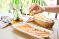 Woman squeeze the juice of a lemon on salted and smoked salmon or trout fillet. Thin slices of red fish with lemon Royalty Free Stock Photo