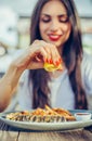 Woman squeeze lemon on portion of fish in a restaurant Royalty Free Stock Photo