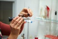 A woman squeezes grapes into a refractometer