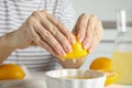 Woman squeezing lemon juice into bowl, closeup Royalty Free Stock Photo