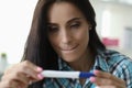 Woman squeezing lips looks test determine pregnancy