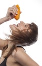 WOMAN SQUEEZING ORANGE Royalty Free Stock Photo