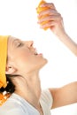 Woman squeezing orange into mouth Royalty Free Stock Photo