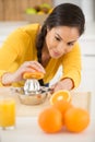 woman squeezing oranges for juice