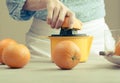 Woman squeezing oranges for juice