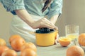 Woman squeezing oranges for juice