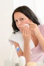 Woman squeezing pimple cleaning acne skin