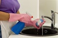 Woman squirting detergent onto a sponge