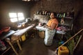 Woman in Sri Lanka in a poor kitchen.