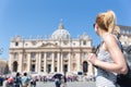Woman on St. Peter`s Square in Vatican in front of St. Peter`s Basilica. Royalty Free Stock Photo
