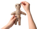 Woman stabbing voodoo doll with pin on white background, closeup