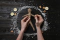 Woman stabbing voodoo doll with pins at table, top view