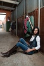 Woman in a stable before riding her horse Royalty Free Stock Photo