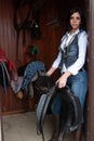 Woman in a stable before riding her horse Royalty Free Stock Photo