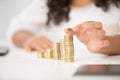 woman stacking euro coins