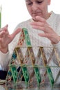 Woman stacking a tower from playing cards. Royalty Free Stock Photo